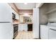 Functional kitchen featuring white appliances and adjacent laundry closet at 159-1 Weehawka Way # 159-1, Pawleys Island, SC 29585