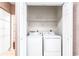 Bright laundry area features a white washer, dryer, shelving, and bi-fold closet at 159-1 Weehawka Way # 159-1, Pawleys Island, SC 29585