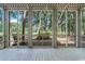 Covered porch with views of lush trees and greenery at 159-1 Weehawka Way # 159-1, Pawleys Island, SC 29585