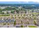 The aerial view shows townhomes with parking near the ocean and bordering a green forest at 1600 Deer Creek Rd. # F, Myrtle Beach, SC 29575