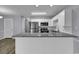 Open kitchen area featuring stainless steel appliances, a subway tile backsplash, and a granite countertop island at 1600 Deer Creek Rd. # F, Myrtle Beach, SC 29575