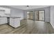 Spacious living room featuring hardwood floors, a modern ceiling fan, and sliding glass doors to outdoor deck at 1600 Deer Creek Rd. # F, Myrtle Beach, SC 29575