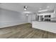 Open living space with hardwood floors, ceiling fan, and eat-in kitchen with stainless appliances at 1600 Deer Creek Rd. # F, Myrtle Beach, SC 29575