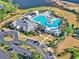 Aerial view of community pool, clubhouse, parking lot, and a beautifully landscaped surrounding area at 1631 Hepburn Dr., Little River, SC 29566