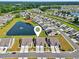 Aerial view of new homes adjacent to a pond with water feature in a well-maintained community at 1631 Hepburn Dr., Little River, SC 29566