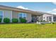 A well-maintained backyard with a screened-in patio and lush landscaping at 1631 Hepburn Dr., Little River, SC 29566