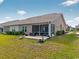 A cozy screened-in porch and patio are nestled in the backyard of a home at 1631 Hepburn Dr., Little River, SC 29566