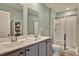 Bathroom features double sinks, framed mirrors, and a walk-in shower at 1631 Hepburn Dr., Little River, SC 29566
