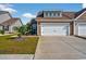 Attractive townhome exterior with neat lawn, concrete driveway, and attached garage, bathed in the sun at 1631 Hepburn Dr., Little River, SC 29566