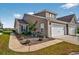 Inviting exterior view of townhome with well-maintained landscaping and attached garage, under a bright, blue sky at 1631 Hepburn Dr., Little River, SC 29566