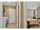 Laundry room located between the main bedroom and an additional bedroom at 1631 Hepburn Dr., Little River, SC 29566