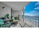 Relaxing balcony with outdoor seating, plants, and a stunning ocean view of the beach at 1990 N Waccamaw Dr. # 1008, Murrells Inlet, SC 29576