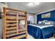 This is a bedroom with a bunk bed and a queen bed with blue colored linens at 1990 N Waccamaw Dr. # 1008, Murrells Inlet, SC 29576