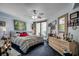 Comfortable bedroom featuring a large bed, a ceiling fan, ample natural light, and tasteful decorations at 1990 N Waccamaw Dr. # 1008, Murrells Inlet, SC 29576