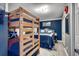 This is a comfy bedroom with a bunk bed and a queen bed with blue colored linens at 1990 N Waccamaw Dr. # 1008, Murrells Inlet, SC 29576