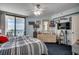 Comfortable bedroom featuring a large bed, a ceiling fan, ample natural light, and tasteful decorations at 1990 N Waccamaw Dr. # 1008, Murrells Inlet, SC 29576