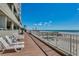 This is a deck overlooking the beach with chairs to relax on at 1990 N Waccamaw Dr. # 1008, Murrells Inlet, SC 29576