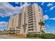 Spacious condo building with private balconies, ocean views, and beautifully landscaped grounds with palm trees at 1990 N Waccamaw Dr. # 1008, Murrells Inlet, SC 29576