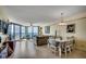 Open living room features a dining area, balcony access with ocean views, and cozy furnishings at 1990 N Waccamaw Dr. # 1008, Murrells Inlet, SC 29576