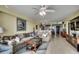 Spacious living room flows into the kitchen and includes ocean views, a ceiling fan, and stylish decor at 1990 N Waccamaw Dr. # 1008, Murrells Inlet, SC 29576