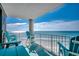Balcony offering direct ocean views, complete with comfortable blue Adirondack chairs at 1990 N Waccamaw Dr. # 807, Murrells Inlet, SC 29576