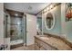 Bathroom featuring a tiled walk-in shower and granite vanity with decorative mirror and wallpaper border at 1990 N Waccamaw Dr. # 807, Murrells Inlet, SC 29576