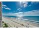 Wide angle view of a sunny beach with pristine sand and clear blue water from a high vantage point at 1990 N Waccamaw Dr. # 807, Murrells Inlet, SC 29576