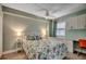Cozy bedroom with floral bedding, a ceiling fan, and a built-in desk and storage space near a window at 1990 N Waccamaw Dr. # 807, Murrells Inlet, SC 29576