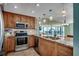 Modern kitchen with stainless steel appliances, granite countertops, and a tile backsplash with ocean view at 1990 N Waccamaw Dr. # 807, Murrells Inlet, SC 29576