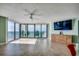 Bright living room featuring large windows overlooking the ocean and a media center with a flat-screen TV at 1990 N Waccamaw Dr. # 807, Murrells Inlet, SC 29576