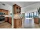 Bright living room open to kitchen with stunning ocean views through large windows and tile flooring at 1990 N Waccamaw Dr. # 807, Murrells Inlet, SC 29576