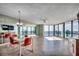 Bright and airy living space with tile flooring, mirrored walls, and stunning ocean views through expansive windows at 1990 N Waccamaw Dr. # 807, Murrells Inlet, SC 29576