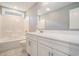 Bathroom with white cabinets, tub and shower combo with white tile surround, and neutral-toned tile flooring at 2004 Potomac Ct., Myrtle Beach, SC 29579