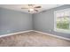 Bedroom with neutral colored walls and carpet, a ceiling fan, and natural light from a window at 2004 Potomac Ct., Myrtle Beach, SC 29579