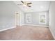 Spacious bedroom with vaulted ceiling, carpet flooring, ceiling fan, and natural light from windows at 2004 Potomac Ct., Myrtle Beach, SC 29579