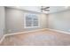 Neutral bedroom featuring plush carpet, a ceiling fan, and large window providing natural light at 2004 Potomac Ct., Myrtle Beach, SC 29579