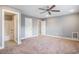 Spacious bedroom featuring plush carpet, ceiling fan, and access to an ensuite bathroom at 2004 Potomac Ct., Myrtle Beach, SC 29579