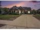 Charming brick home with a well-manicured lawn and long driveway leading to the attached garage at 2004 Potomac Ct., Myrtle Beach, SC 29579