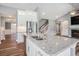 Spacious kitchen island with stainless steel sink, granite countertops, and white cabinetry at 2004 Potomac Ct., Myrtle Beach, SC 29579