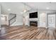 Bright living room features a fireplace, built-in shelving, ceiling fan and wood flooring at 2004 Potomac Ct., Myrtle Beach, SC 29579