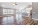 Open-concept living space with wood floors, large windows, and seamless flow into the kitchen at 2004 Potomac Ct., Myrtle Beach, SC 29579