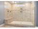 Luxurious tiled shower with built-in bench, rainfall showerhead, and accent tiling at 2004 Potomac Ct., Myrtle Beach, SC 29579