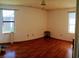 Spacious bedroom with hardwood floors, large windows, and neutral walls at 2005 Greens Blvd. # C-204, Myrtle Beach, SC 29577