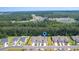 Aerial view showcases the townhome's location within the community near the trees and lake at 2020 Willow Run Dr. # D, Little River, SC 29566