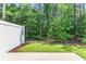 This cozy backyard features lush greenery and a white privacy fence at 2020 Willow Run Dr. # D, Little River, SC 29566