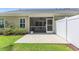View of the patio, screened-in porch, and white fence in the backyard at 2020 Willow Run Dr. # D, Little River, SC 29566