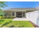 View of the patio, screened-in porch, and white fence in the backyard at 2020 Willow Run Dr. # D, Little River, SC 29566
