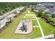 An aerial view showcases the playground and green space in the community with paved walkways at 2020 Willow Run Dr. # D, Little River, SC 29566