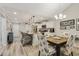 Bright kitchen features white cabinets, stainless appliances, island with barstool seating, and an adjacent dining area at 2020 Willow Run Dr. # D, Little River, SC 29566