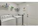 Functional laundry room equipped with a washer, dryer, and storage shelves for convenience at 2020 Willow Run Dr. # D, Little River, SC 29566